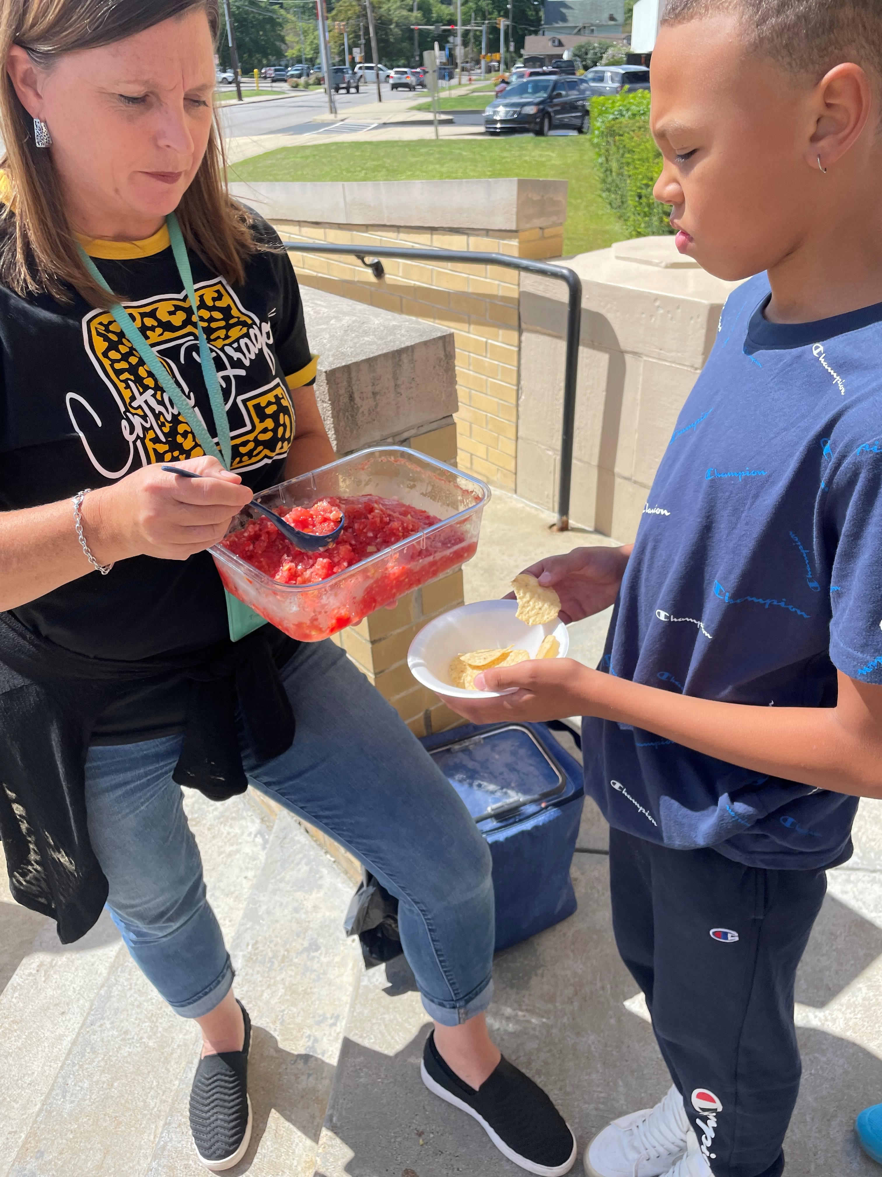 Kids eating tomatoes
